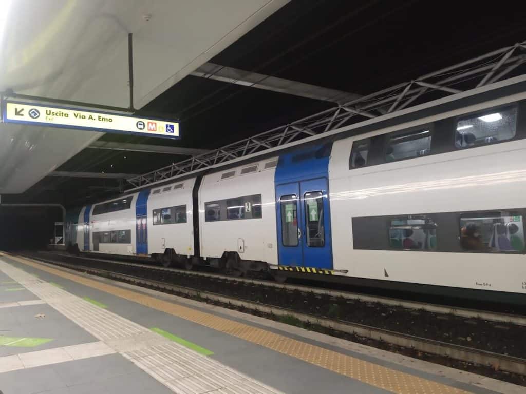 A public train pulled up next to a platform in Italy